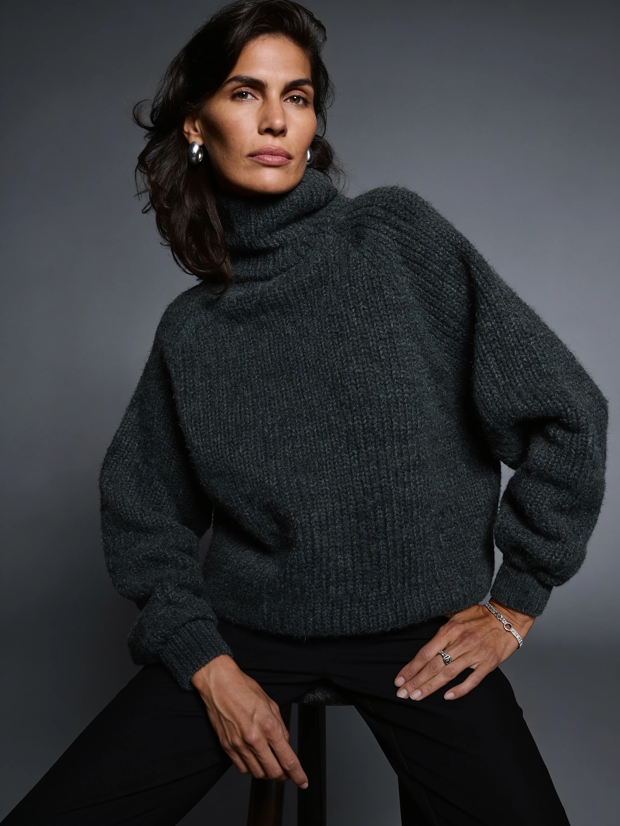 Model wearing charcoal knitwear